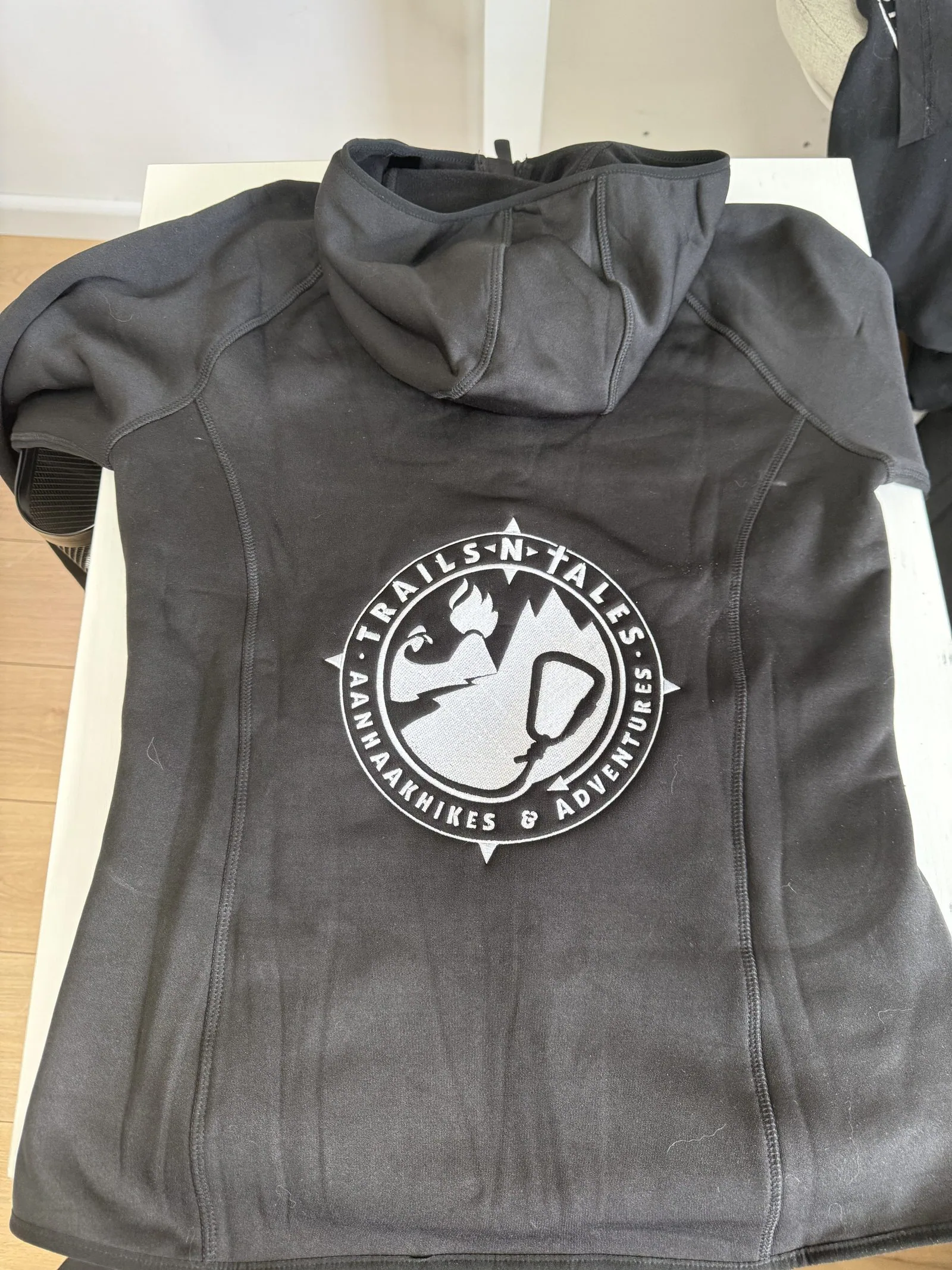 Dark hoodie with Trails-N-Tales print on the back